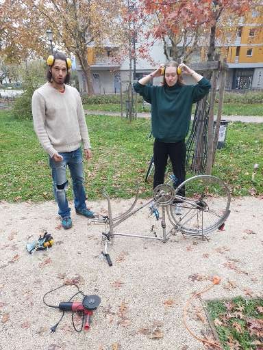 2 members of the low-tech lab who have just finished dismantling a bicycle.